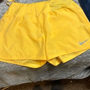 NWOT ~ Women’s yellow Nike Dri-fit shorts.